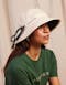Model wearing the Ayrburn Brand Hat in white and top in green